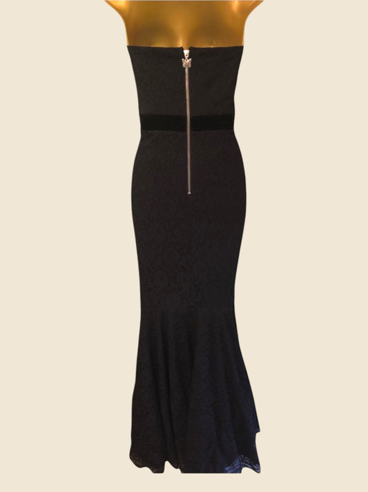 Black dress with a zipper on a mannequin against a beige background