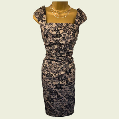 Black lace dress on a mannequin against a beige background
