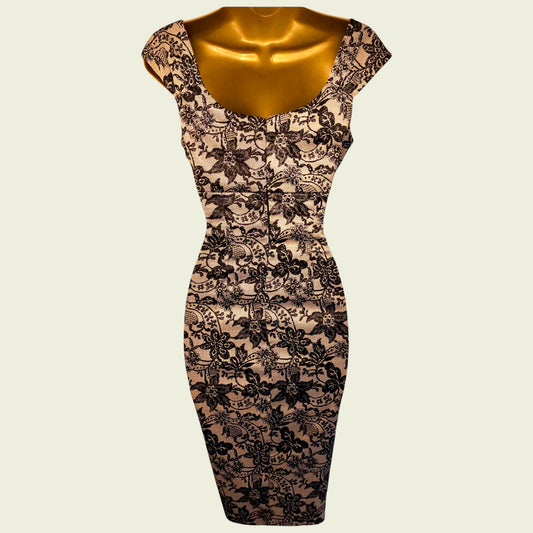 Black lace dress on a mannequin against a beige background
