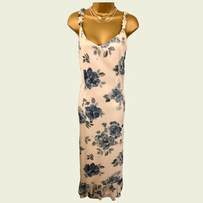 Floral dress on a mannequin against a beige background