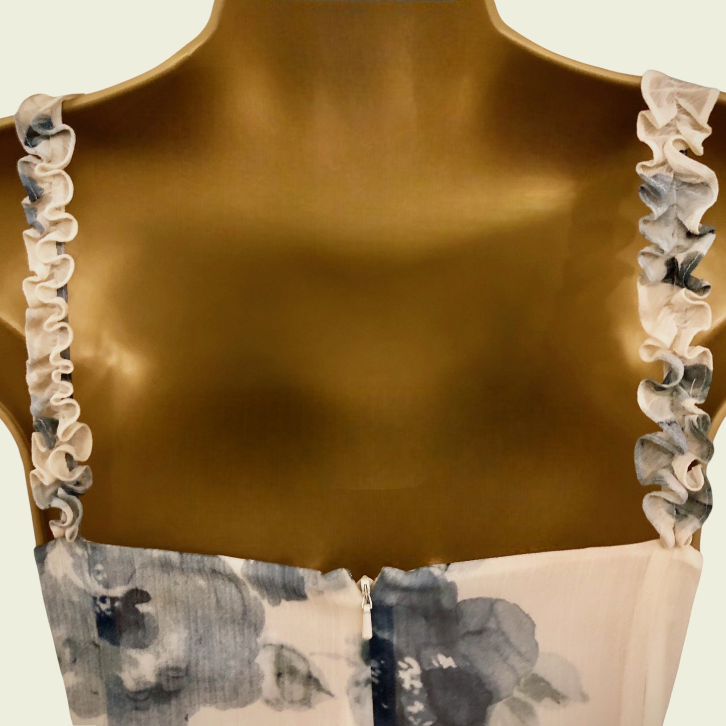 Brown top with floral trim on a neutral background