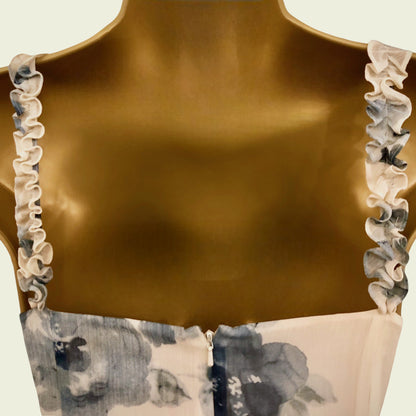 Brown top with floral trim on a neutral background