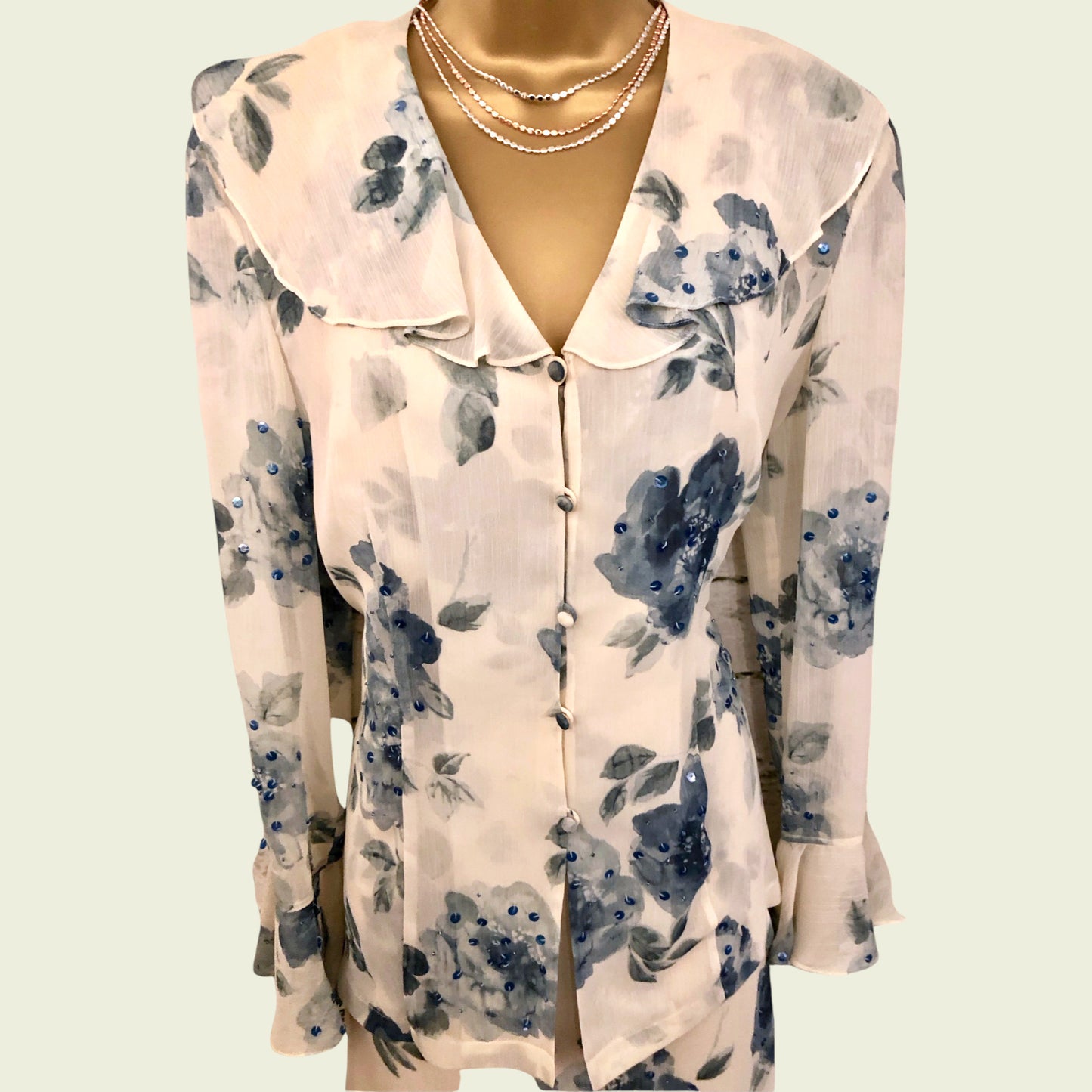 Floral patterned blouse on a mannequin against a light background