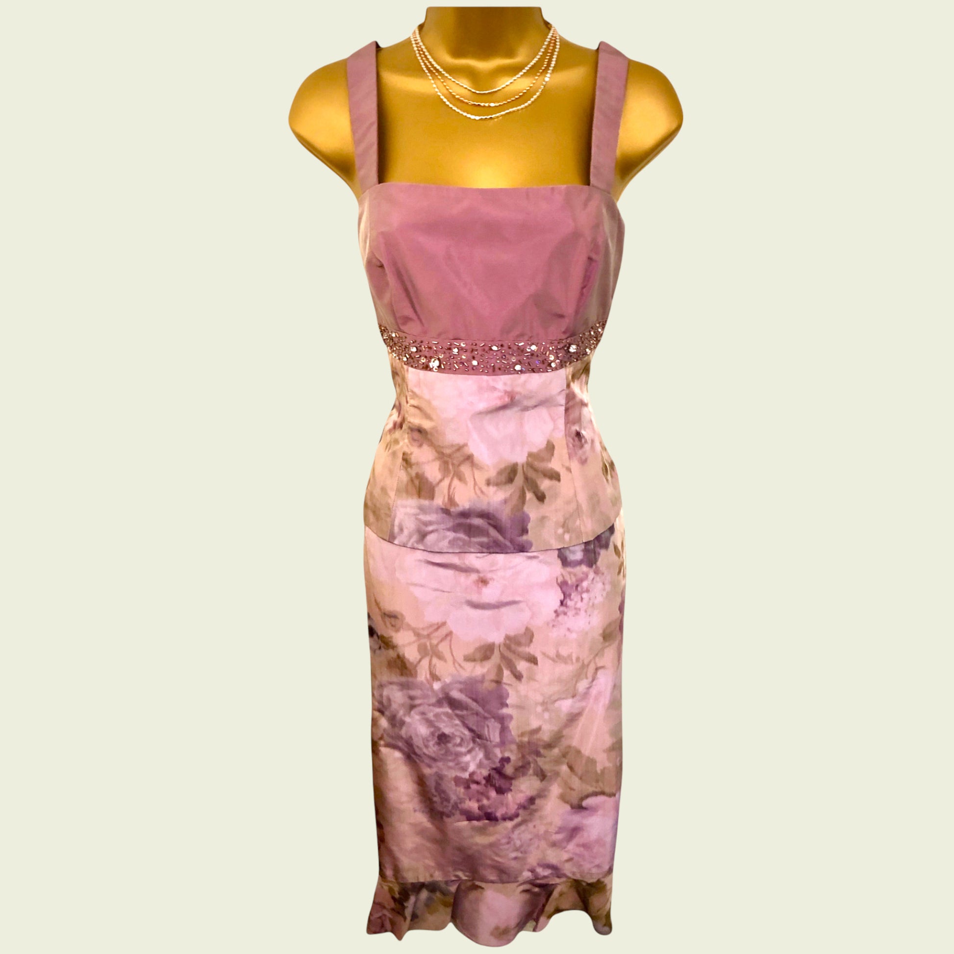 Pink floral dress on a mannequin against a light green background