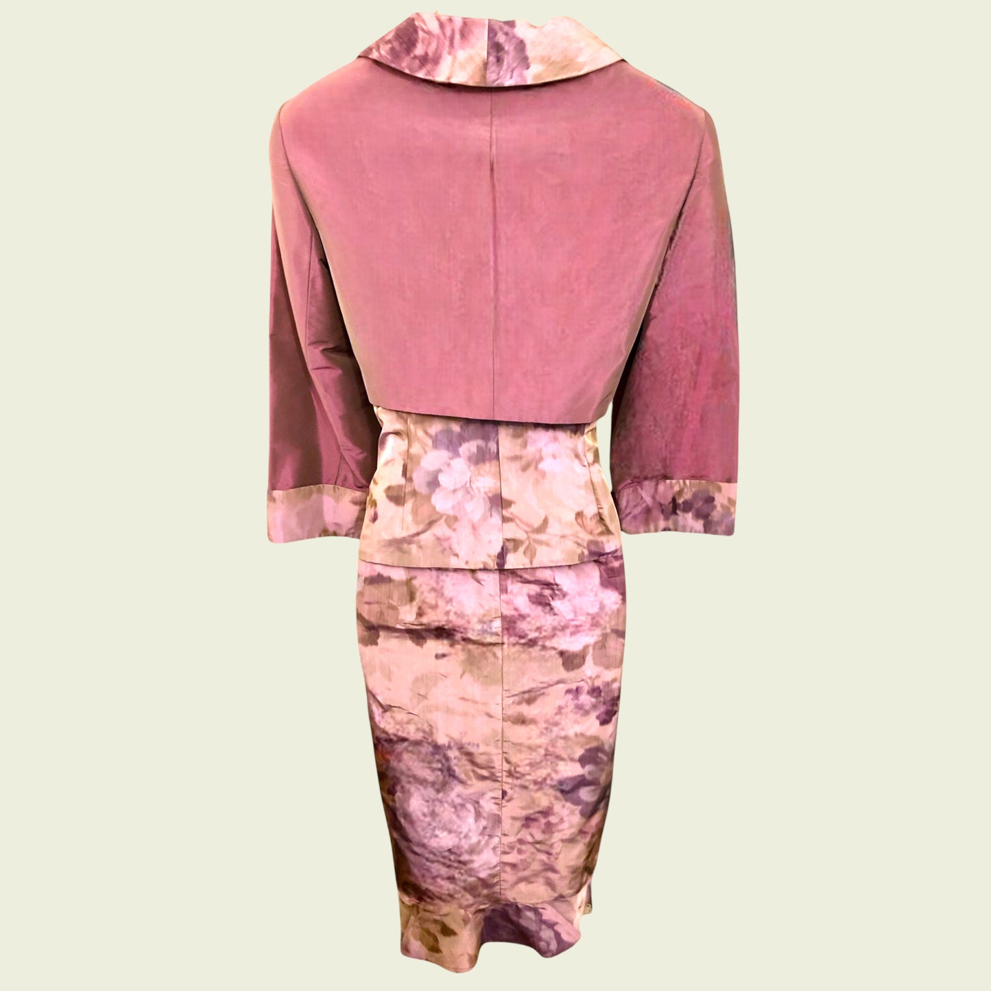 Outfit with a pink top and floral dress on a beige background