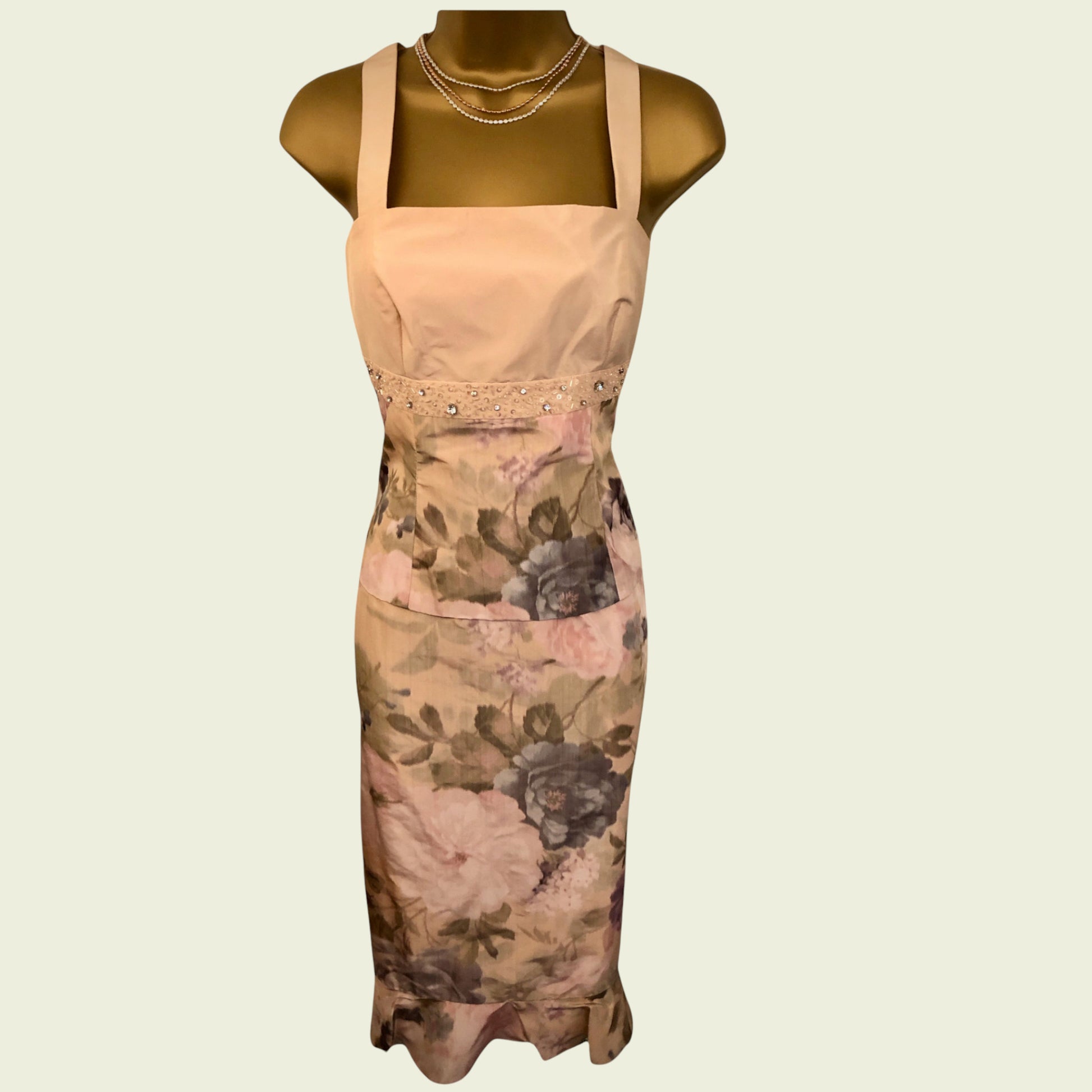 Dress with floral pattern on a mannequin against a beige background