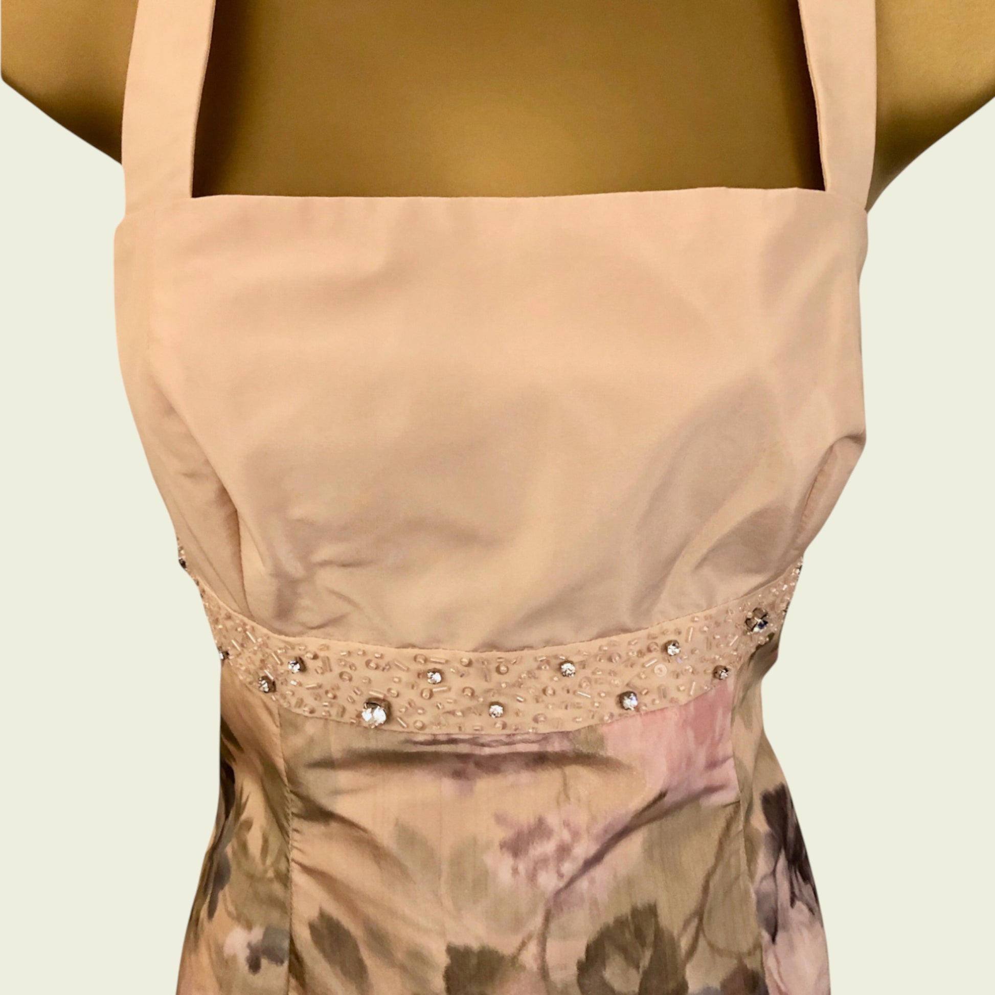 Peach top with decorative trim on a neutral background