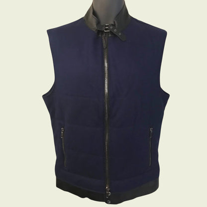 Navy blue vest with black collar and zipper on a beige background