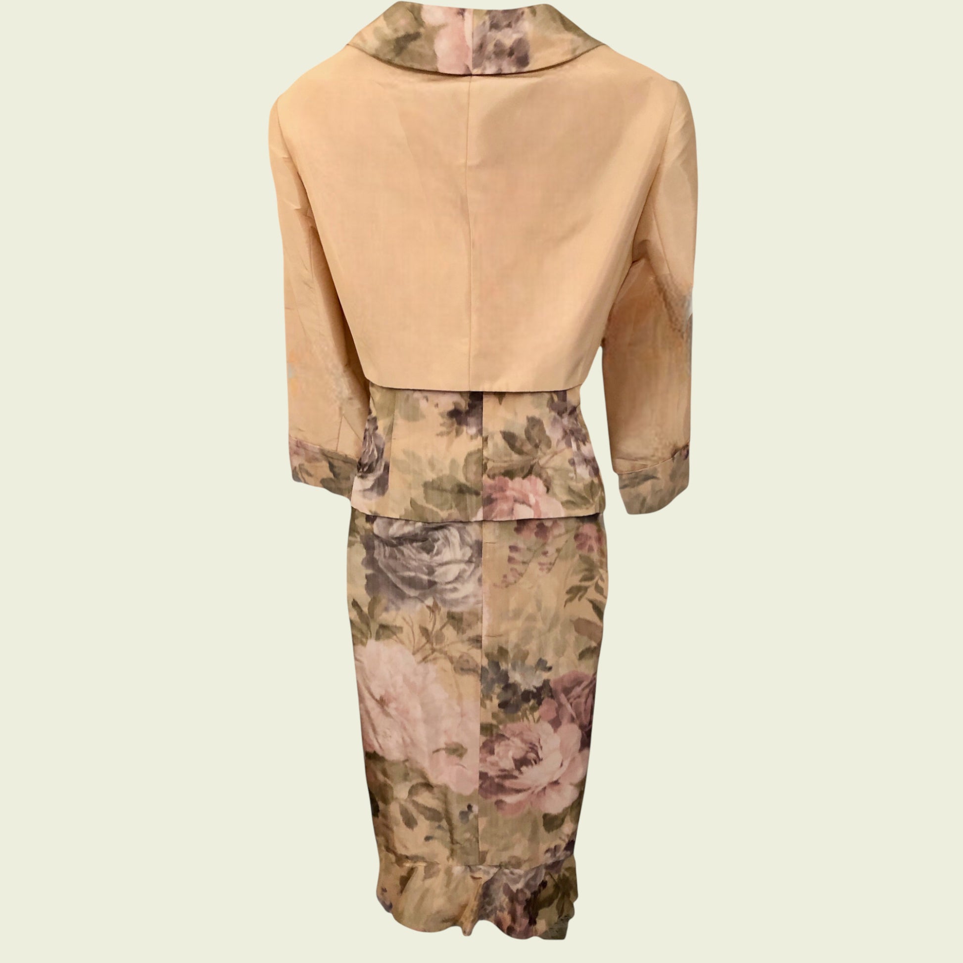 Three-piece outfit with beige jacket and floral skirt on a light beige background