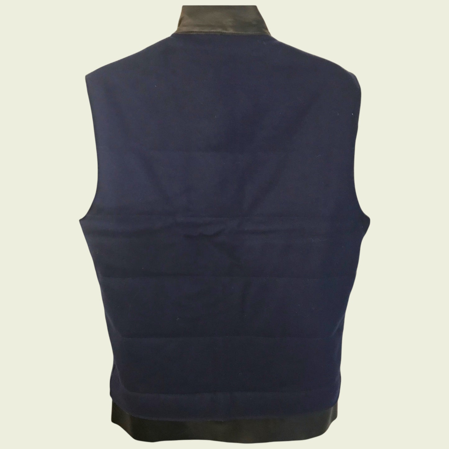Navy blue vest on a beige background