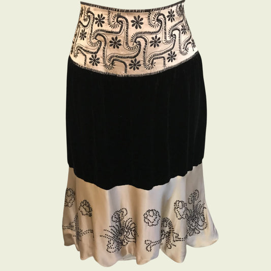 Black and cream embroidered skirt on a beige background