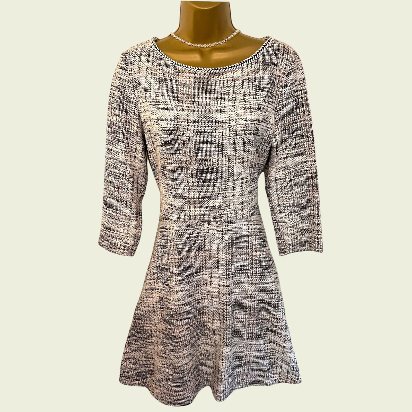 Patterned dress on a mannequin against a plain background