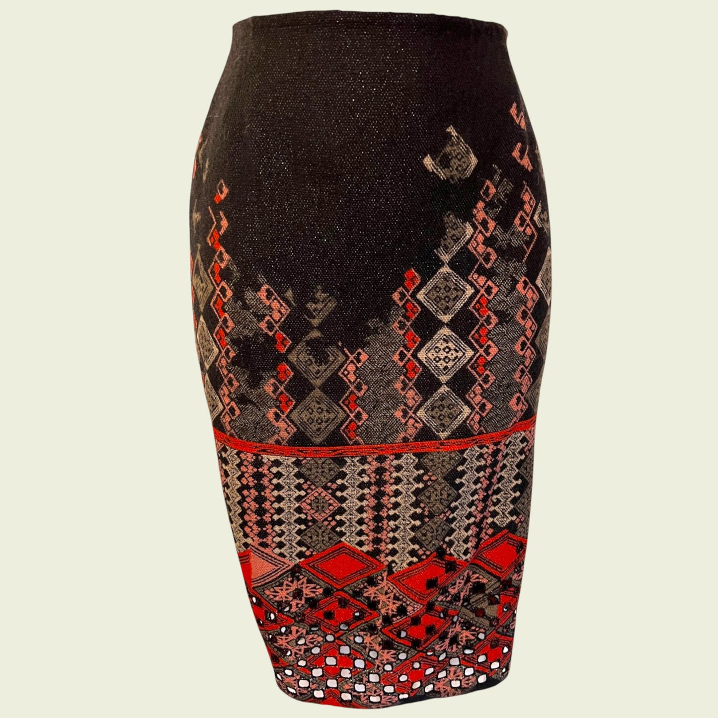 Black pencil skirt with red and beige geometric pattern on a beige background
