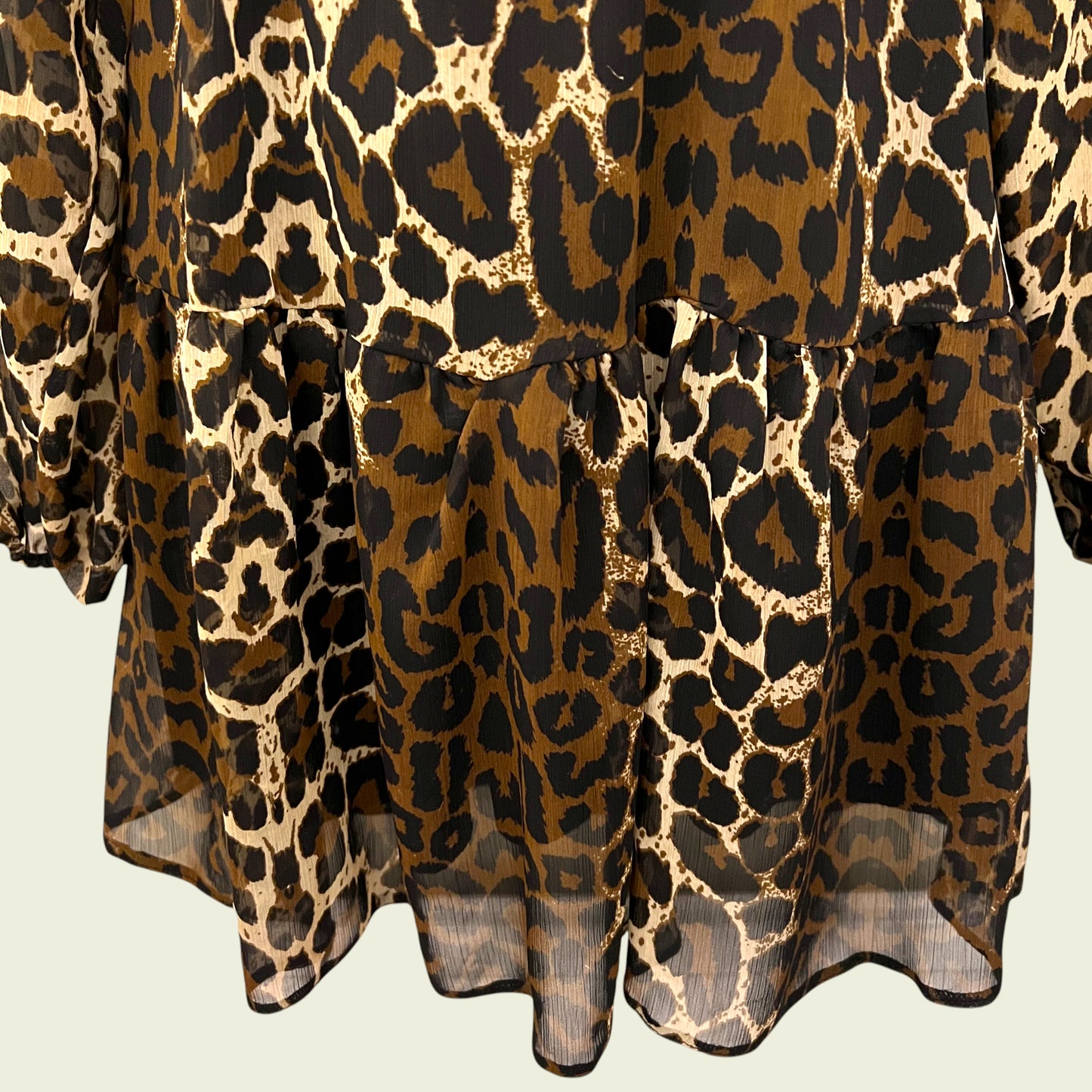 Animal print chiffon dress on beige background