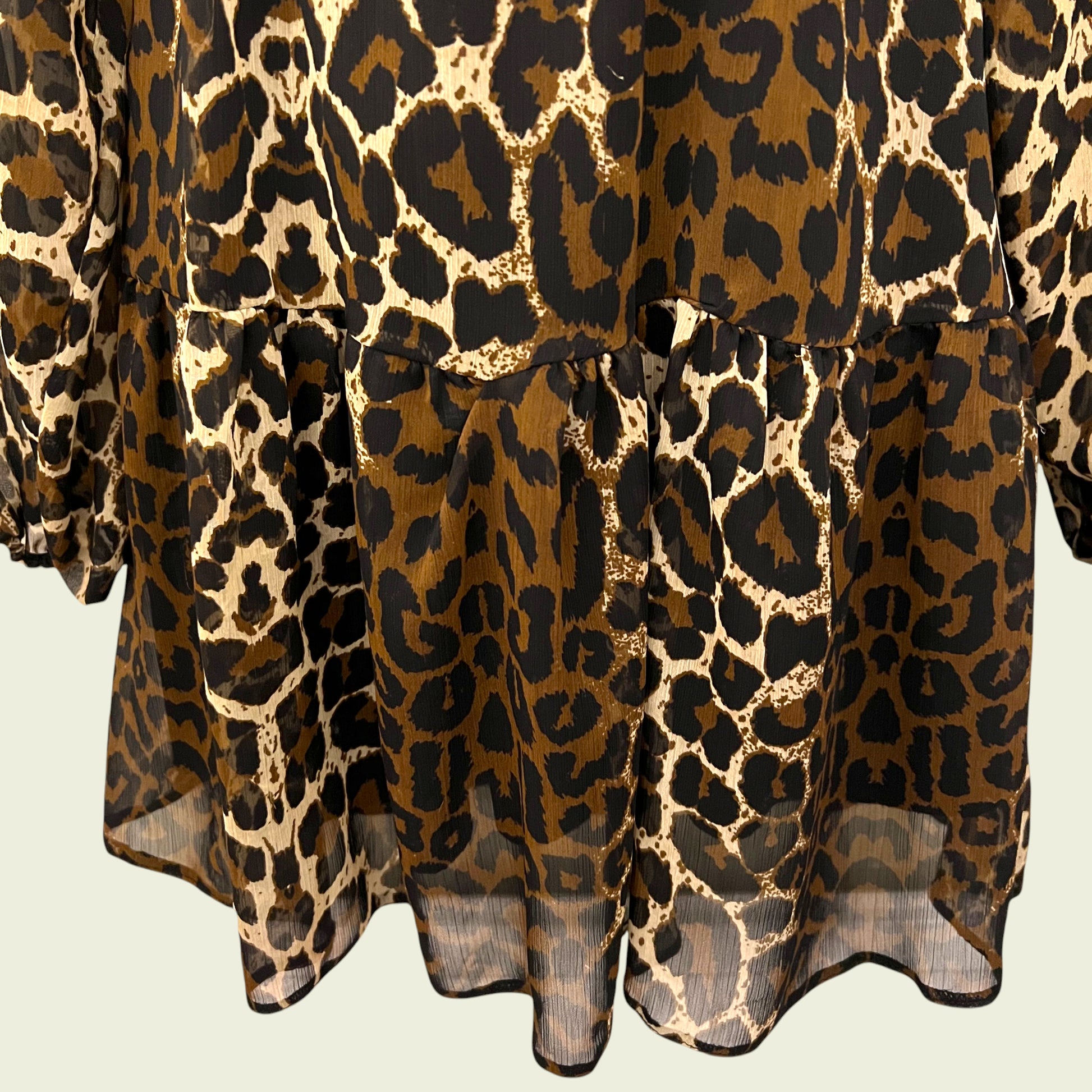 Animal print chiffon dress on beige background