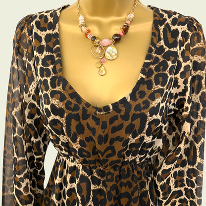 Mannequin wearing animal print chiffon dress on beige background