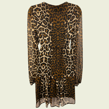 Mannequin wearing animal print chiffon dress on beige background