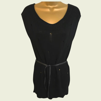 Black sleeveless top on a mannequin against a beige background