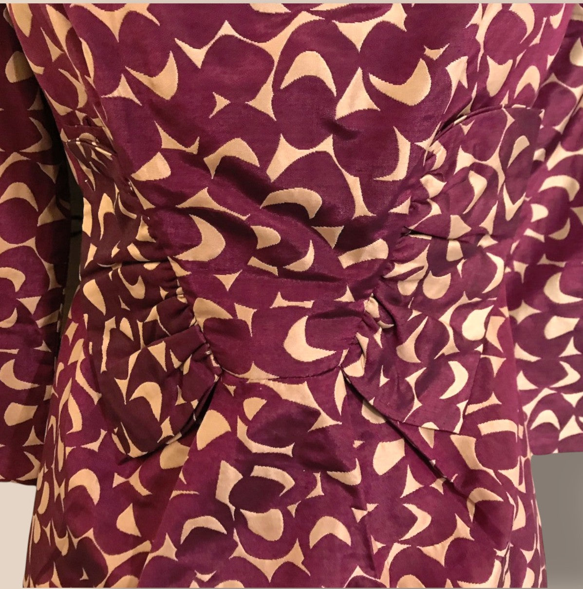 Close-up of a garment with a maroon and beige pattern