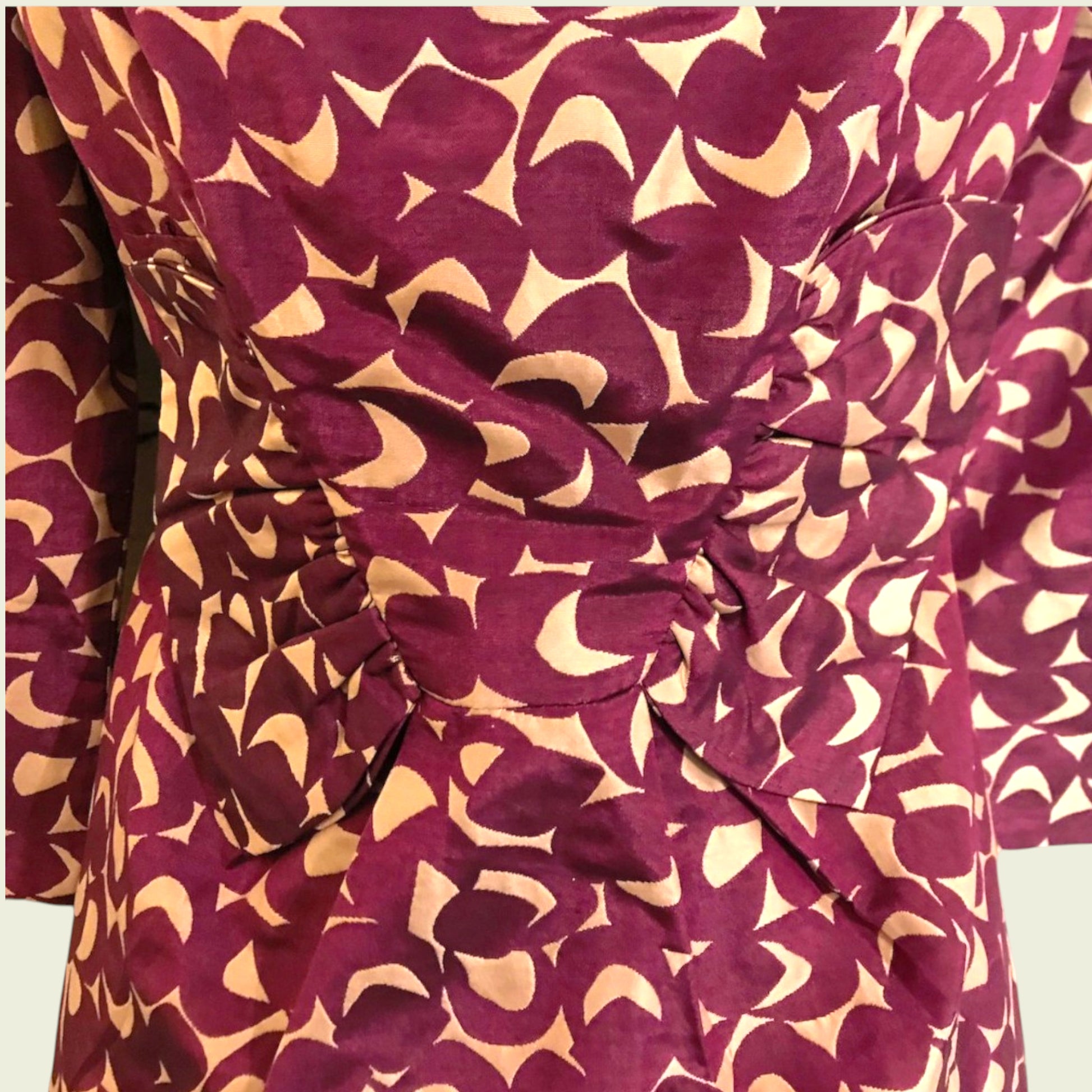 Close-up of a dress with a pattern of crescent moons on a red background