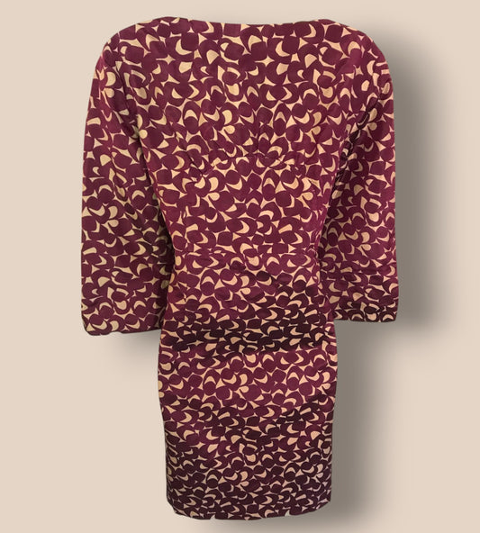 Patterned dress with long sleeves on a beige background