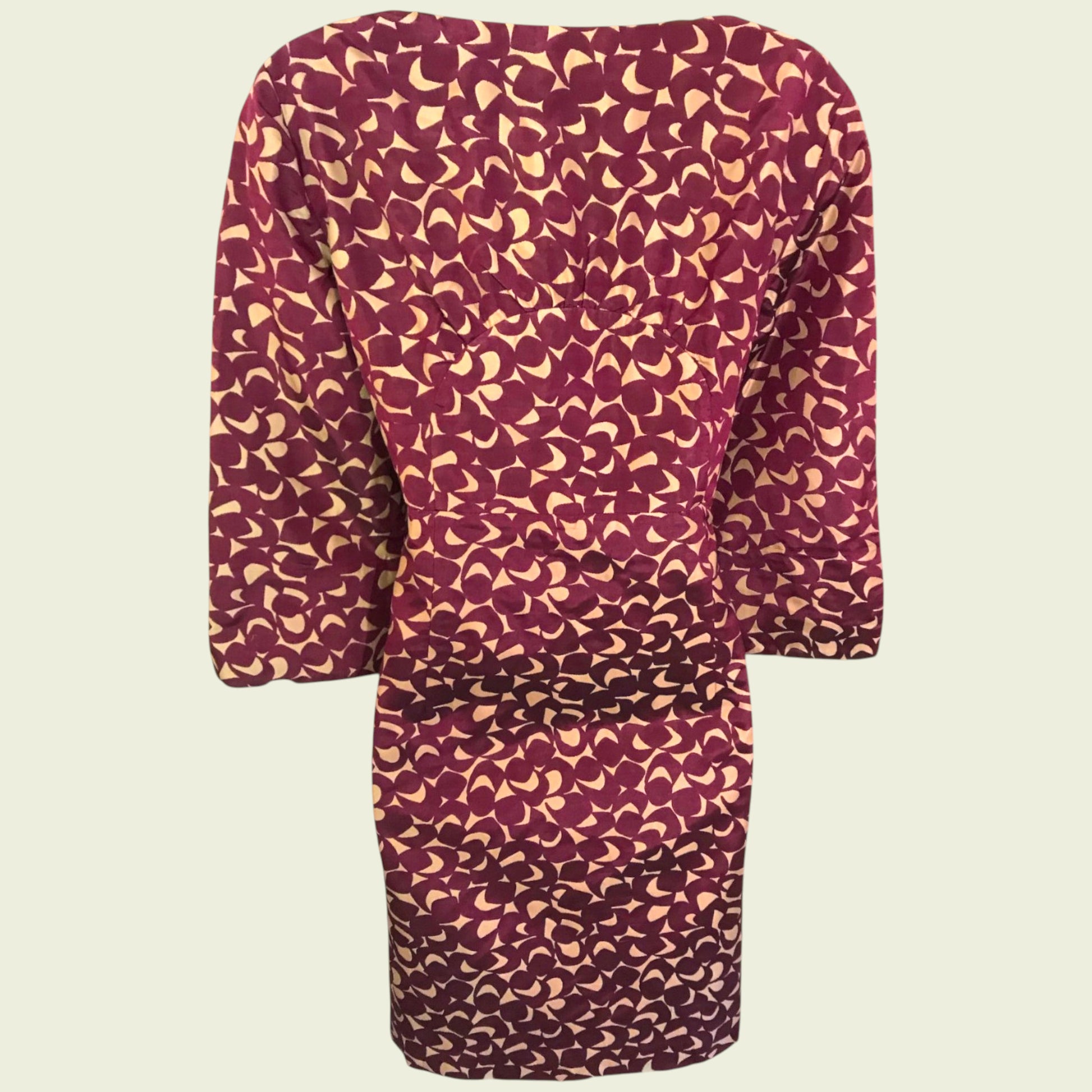 Purple dress with a pattern on a beige background