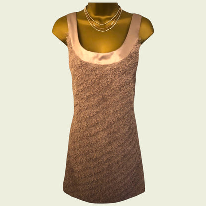 Brown sleeveless dress on a mannequin with a beige background