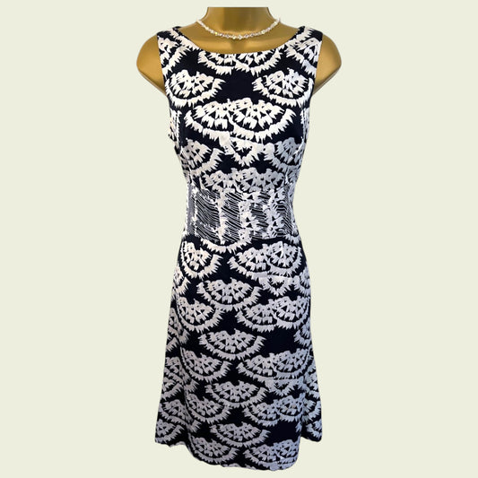 Black and white patterned dress on a mannequin against a beige background