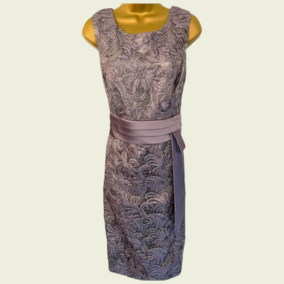 Patterned dress with a belt on a mannequin against a beige background