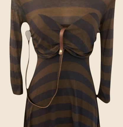 Brown and blue striped dress with a leather strap on a beige background