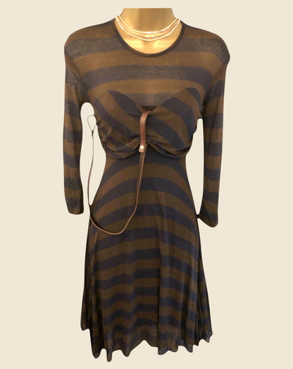 Striped dress with a belt on a mannequin against a beige background