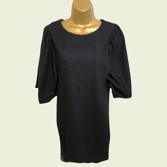 Mannequin wearing black dress on beige background