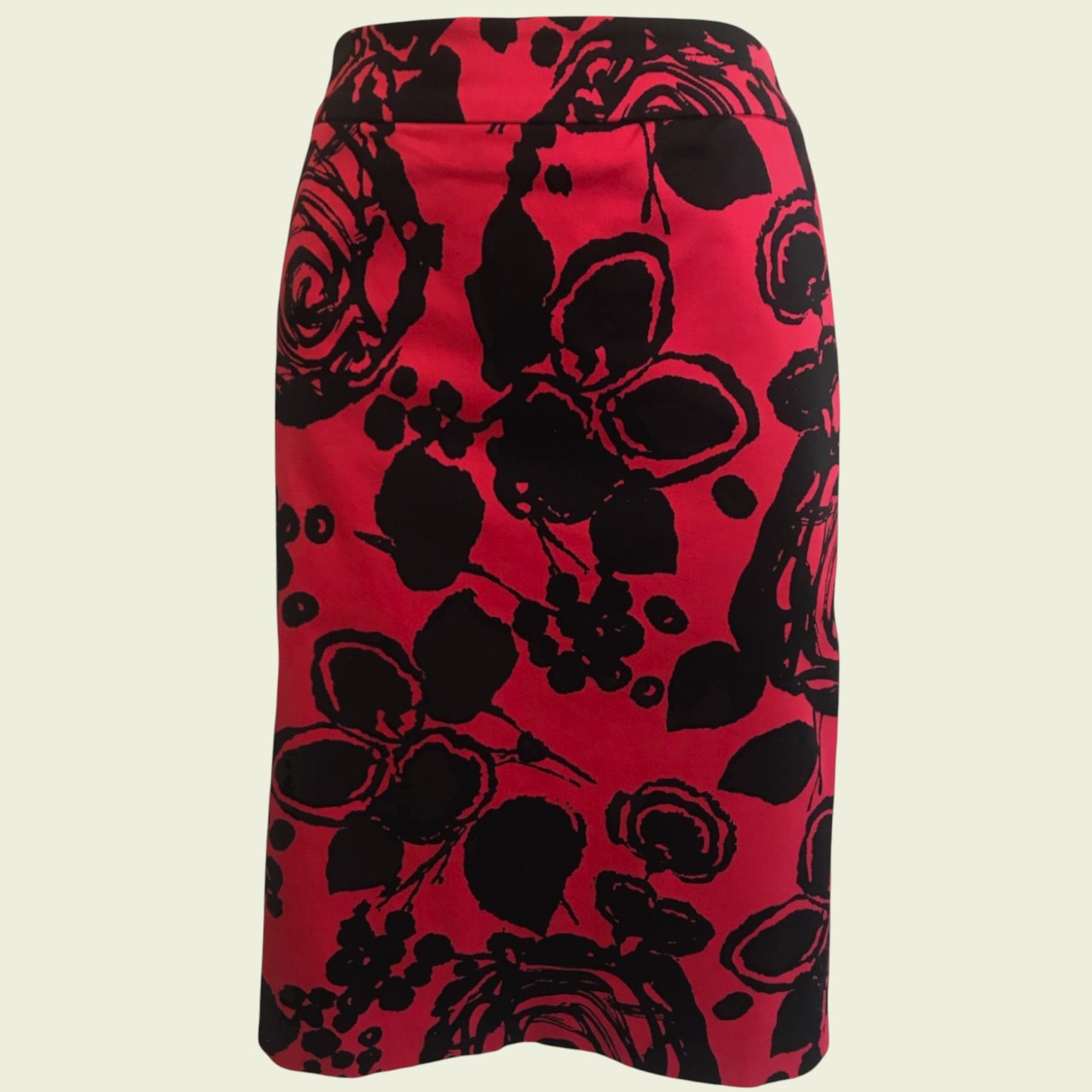 Red skirt with black floral pattern on a beige background
