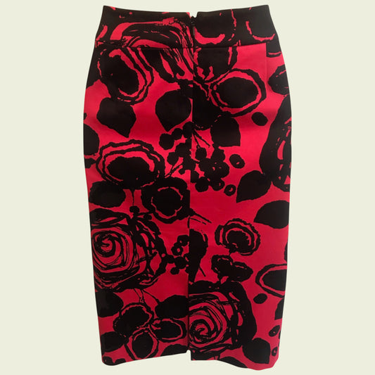 Red skirt with black floral pattern on a beige background