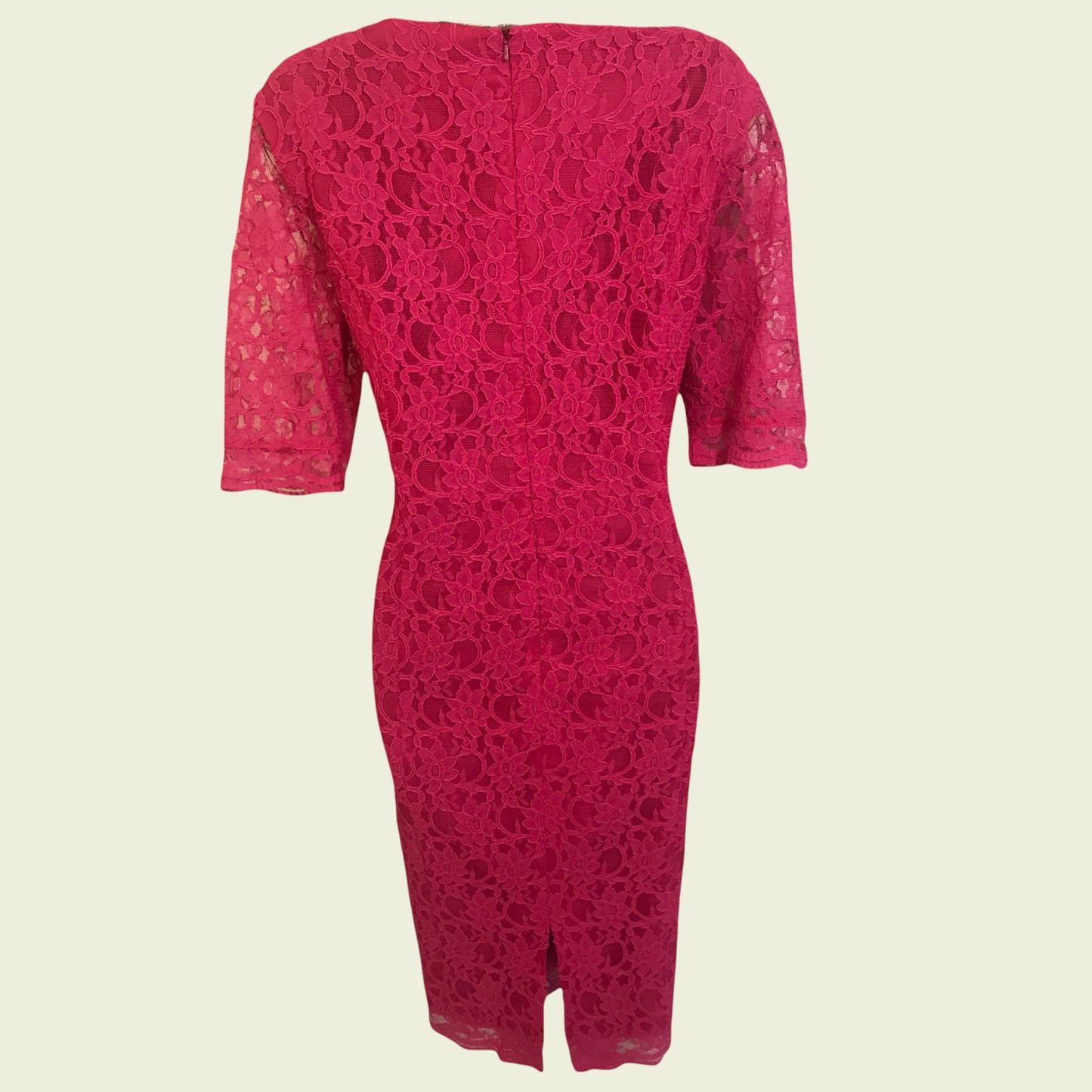 Pink lace dress on beige background