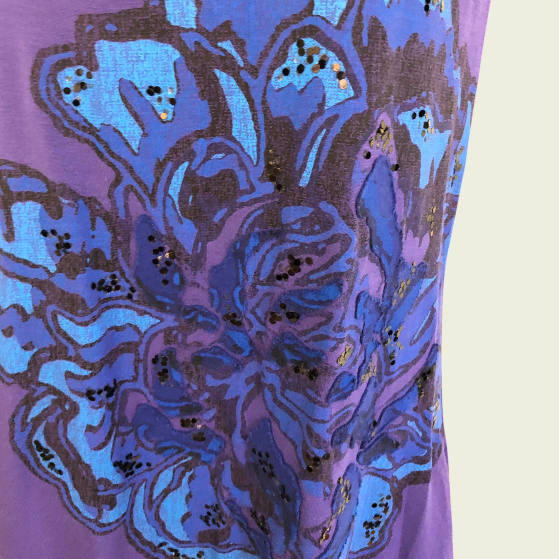 Close-up of a purple fabric with blue floral pattern