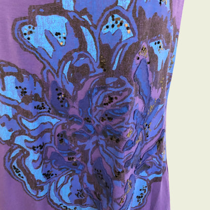 Close-up of a purple fabric with blue floral pattern