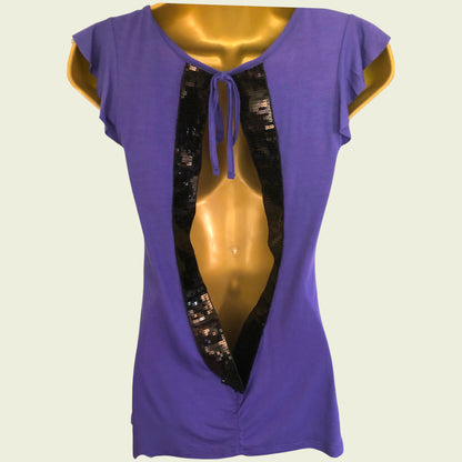 Purple top with black sequin details on a mannequin against a beige background
