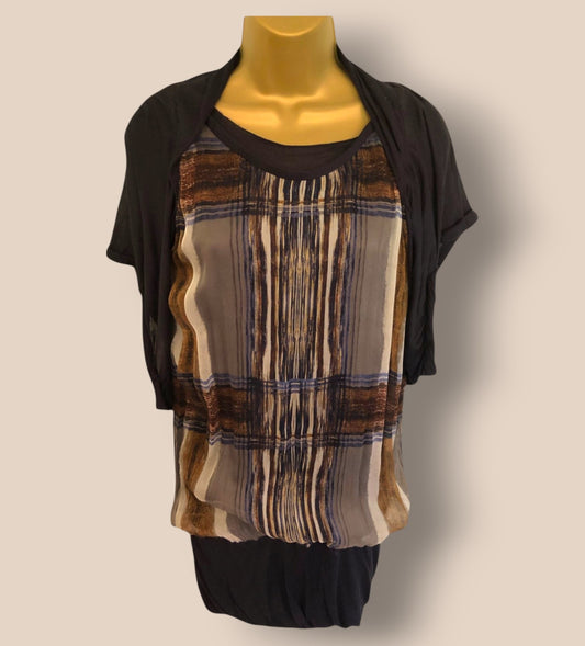 Mannequin wearing a black top with a patterned brown and beige shirt over it on a plain background