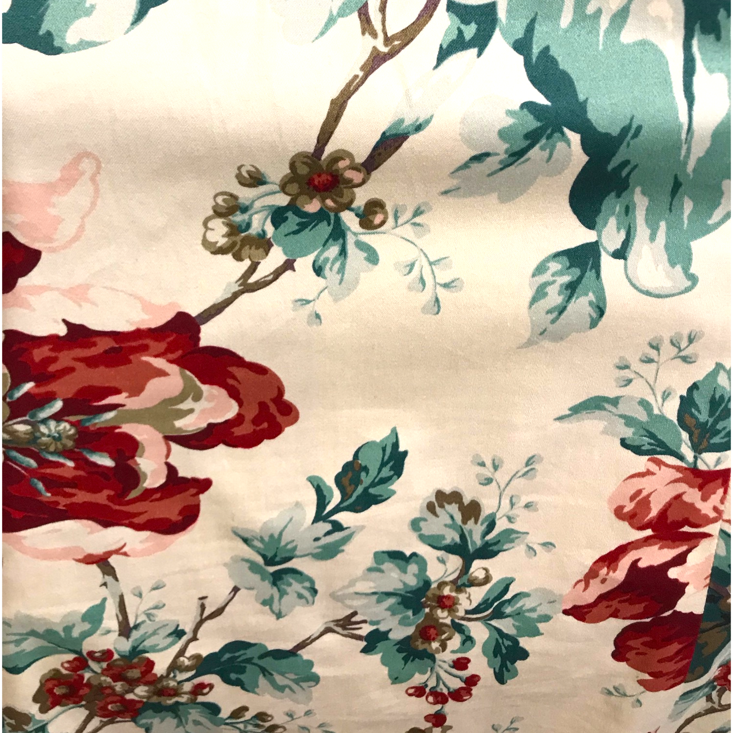 Floral pattern with red, green, and pink colors on a beige background