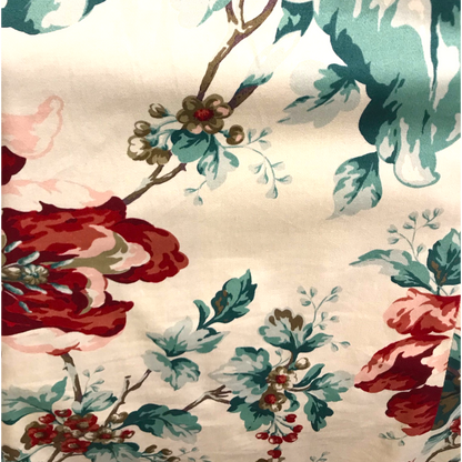 Floral pattern with red, green, and pink colors on a beige background