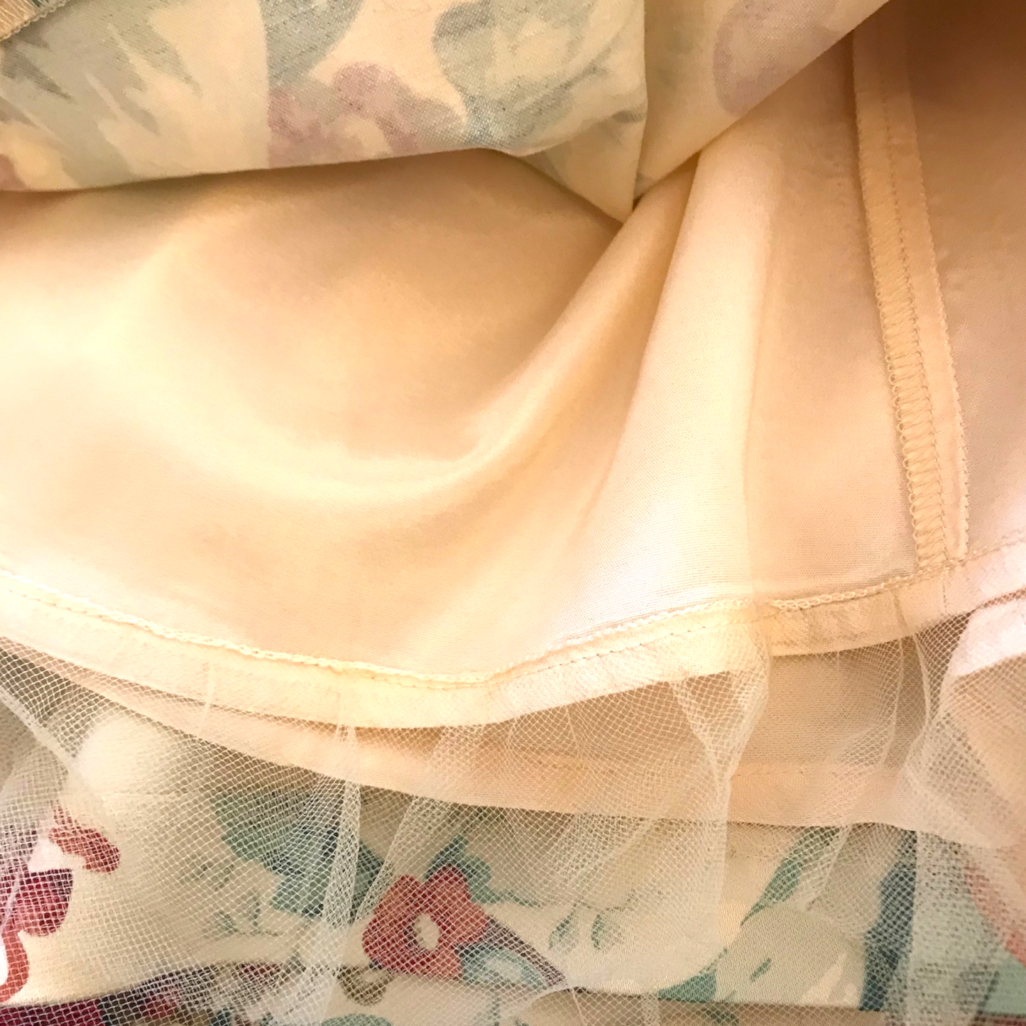 Close-up of beige fabric with floral patterned background