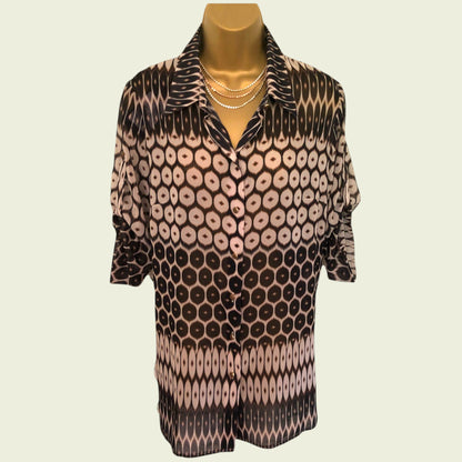 Patterned shirt on a mannequin against a plain background