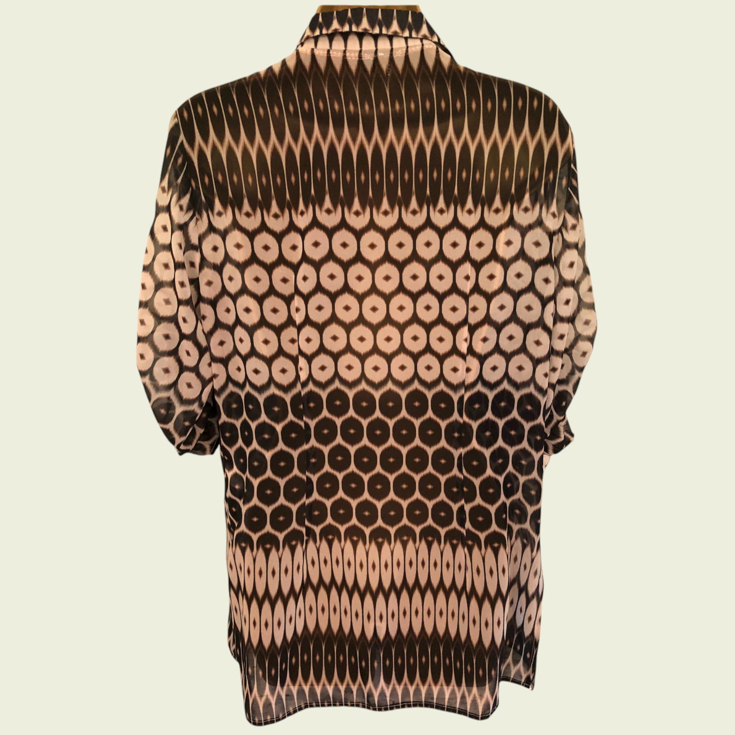 Patterned shirt with black and beige design on a beige background