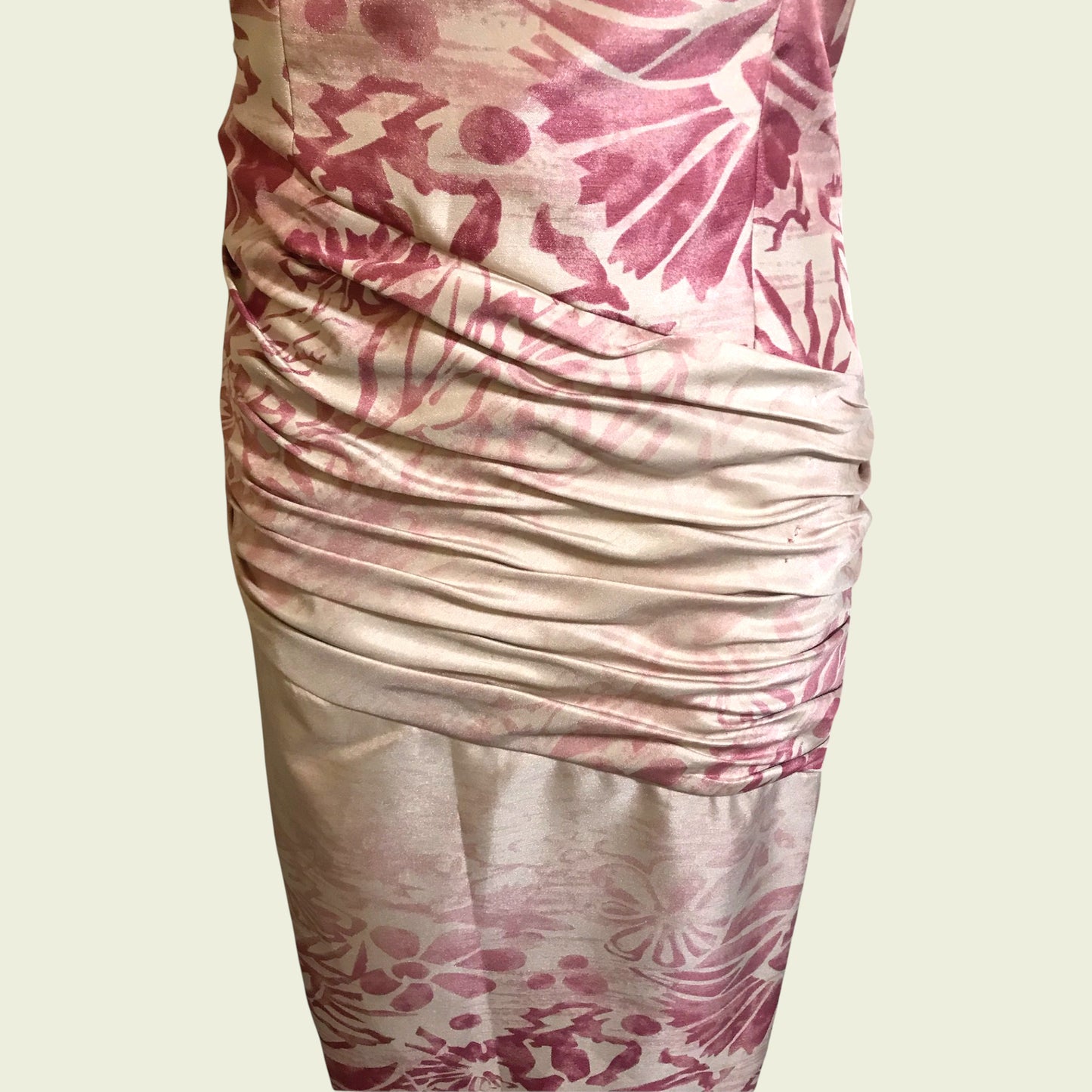 Close up of pink and cream dress on beige background