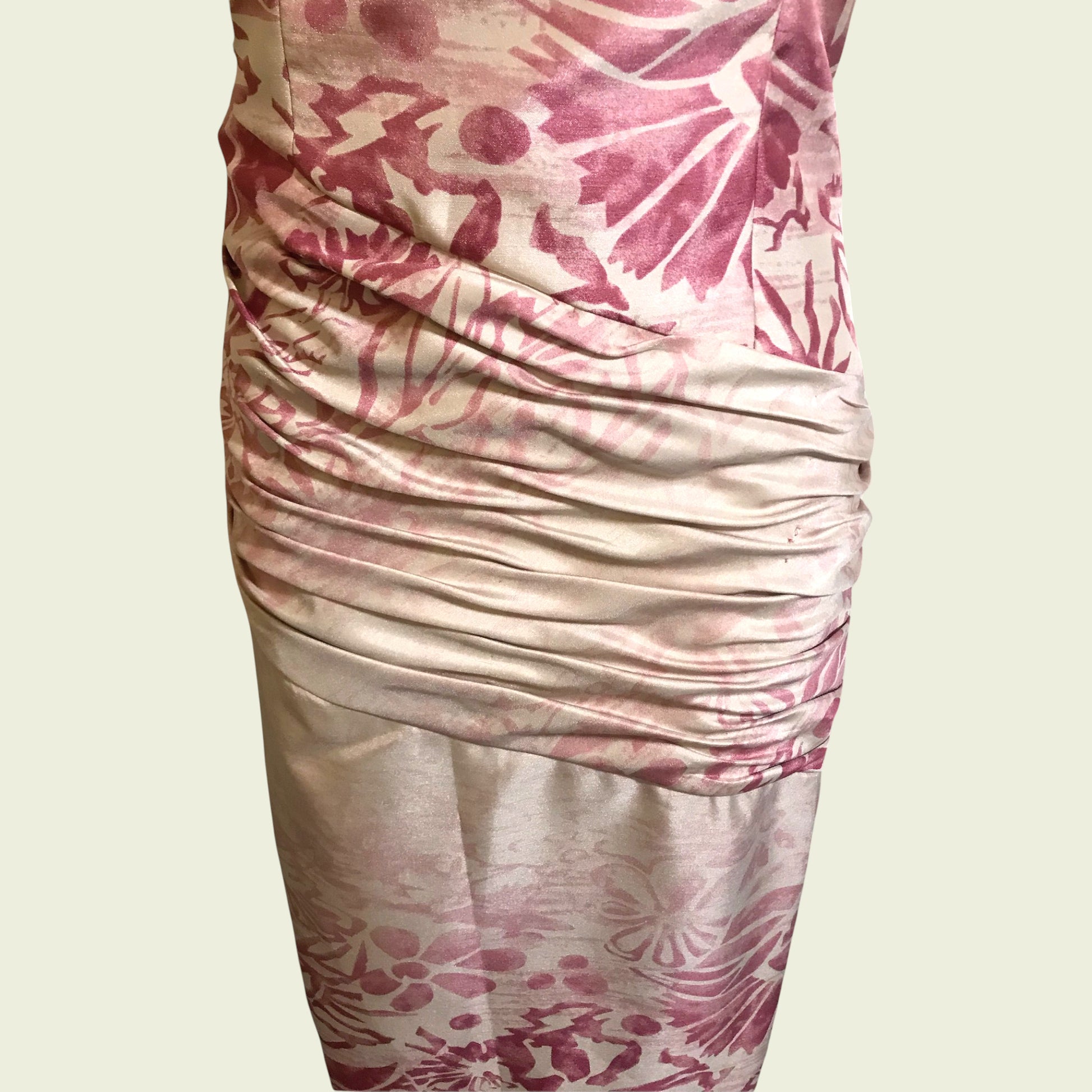 Close up of pink and cream dress on beige background