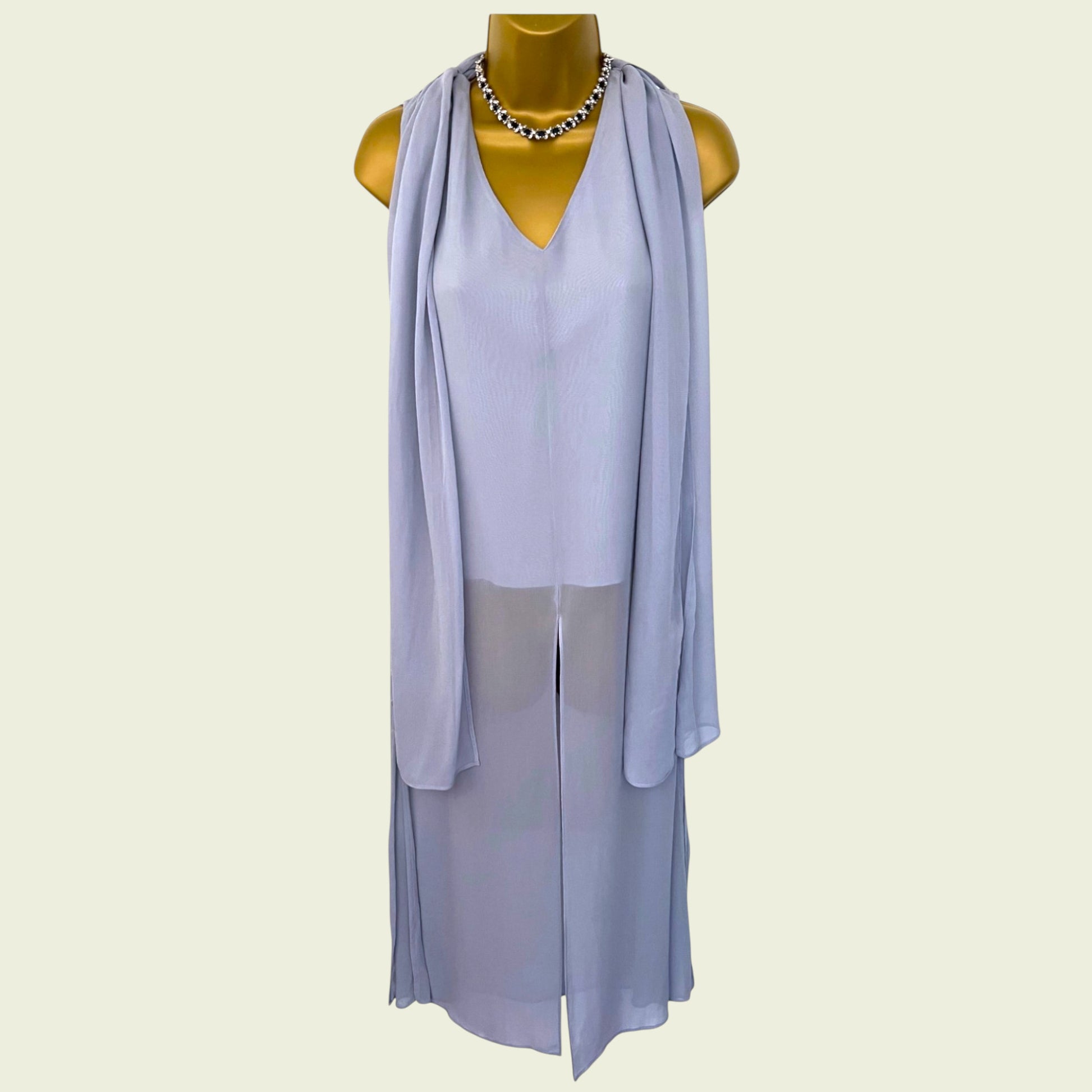 Light purple dress with a draped effect on a mannequin against a white background