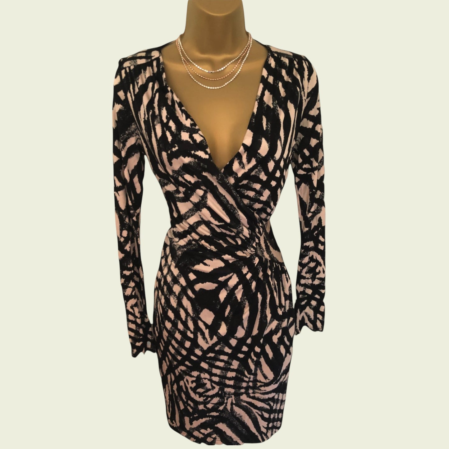 Zebra print dress on a mannequin with a beige background