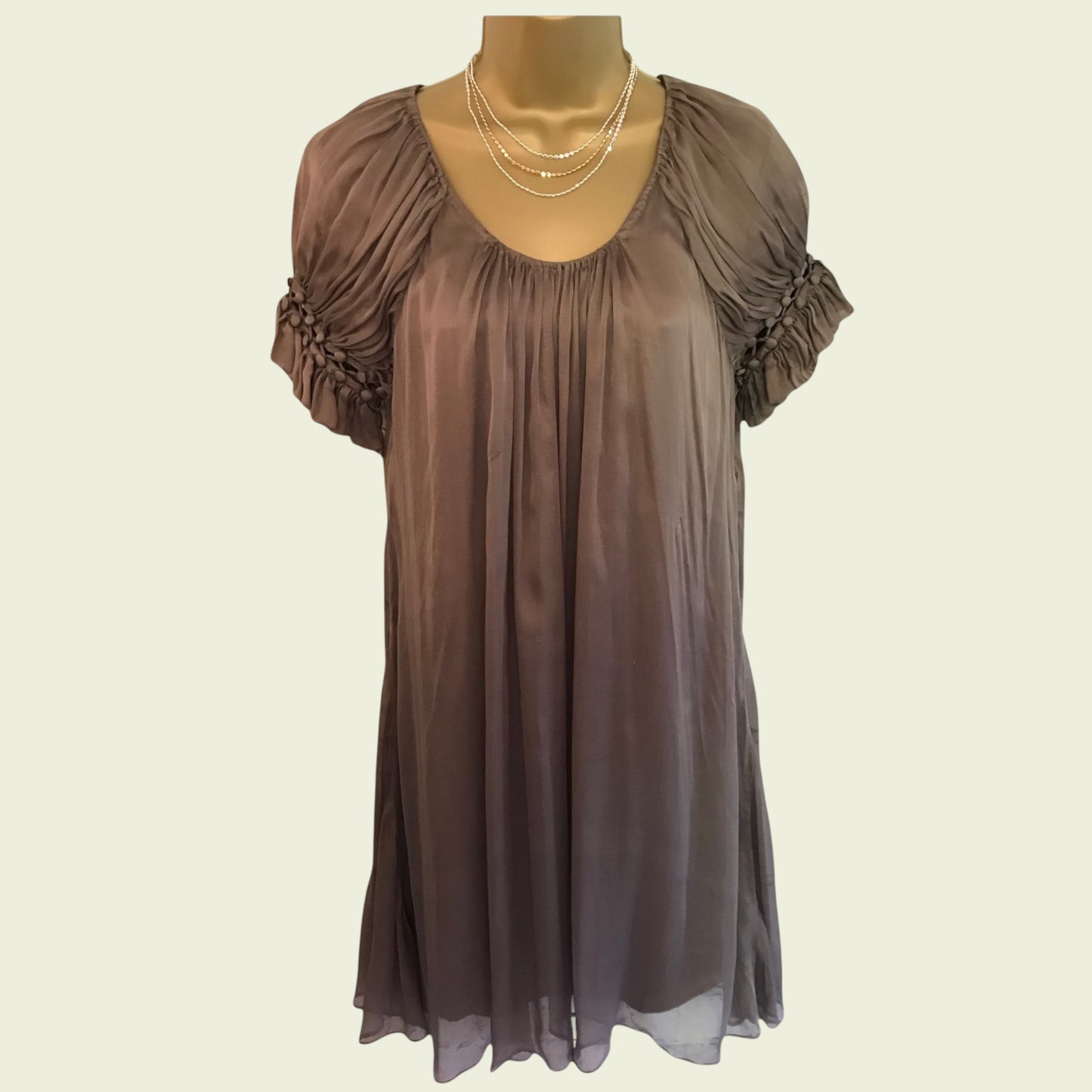 Brown sheer dress on a mannequin with a plain background