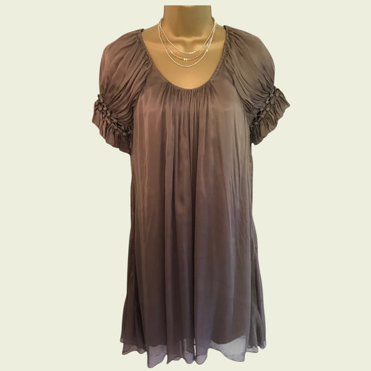 Brown sheer dress on a mannequin with a plain background